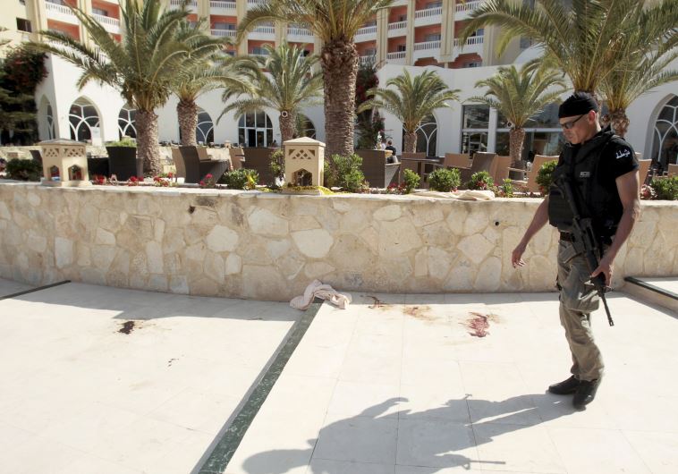  A police officer walks past blood at the Imperiale Marhaba hotel, Tunisia.