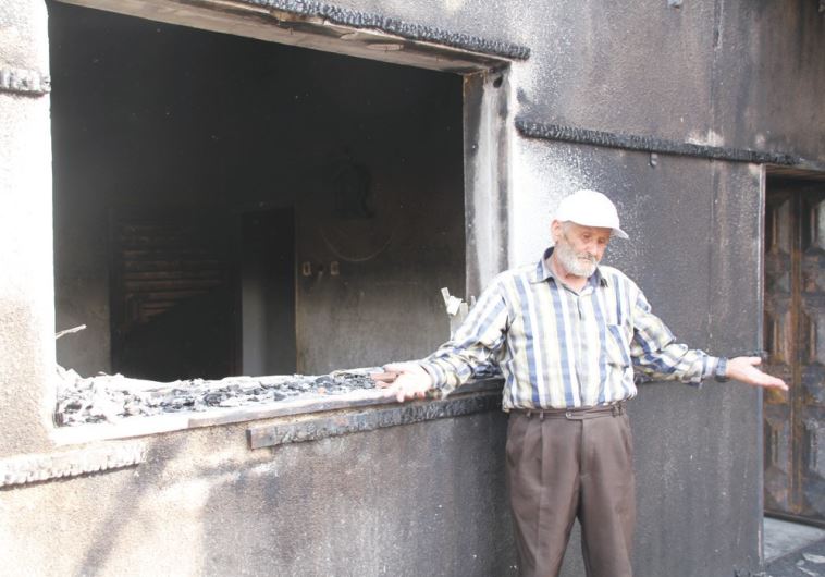 RASHID DAWABSHA stands outside his son Mamoun’s torched home in the Arab village Duma on Sunday