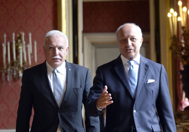 French Foreign Affairs minister Laurent Fabius (R) welcomes his Palestinian counterpart Riyad Al-Mal
