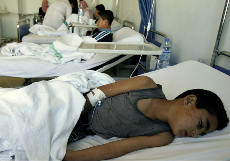 Children receive medical treatment for food poisoning at a hospital in Amman