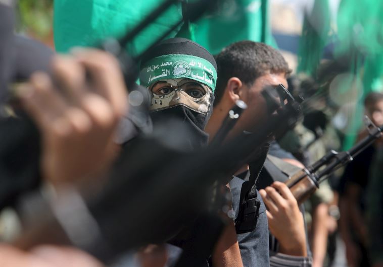 Palestinian Hamas militants take part in a protest against Israel