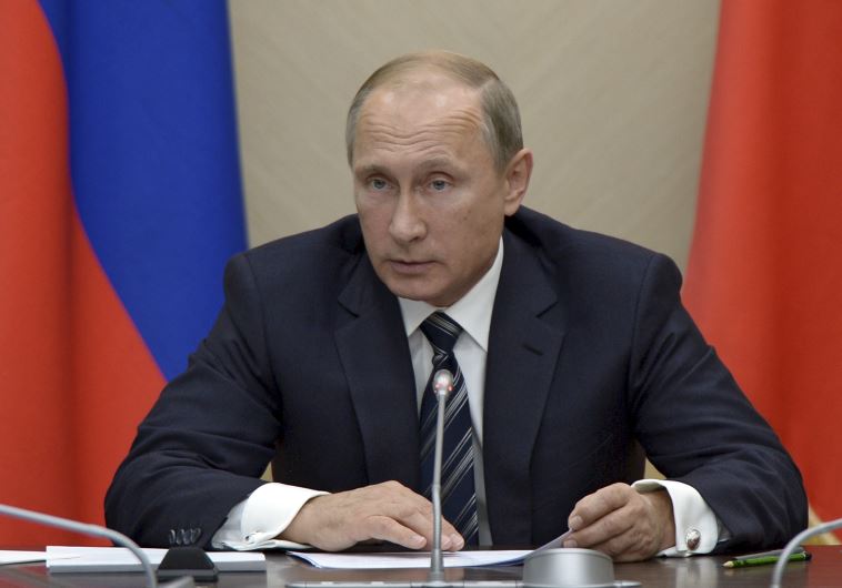 Russian President Vladimir Putin chairs a meeting with members of the government at the Novo-Ogaryov