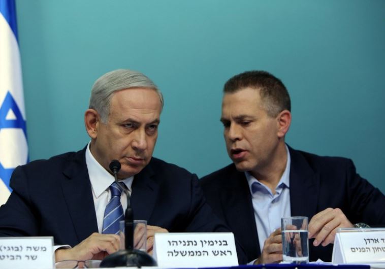 Prime Minister Benjamin Netanyahu listens to Public Security Minister Gilad Erdan (R)