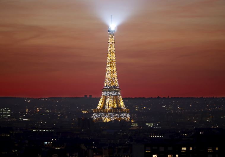 The Eiffel Tower is seen at sunset in Paris