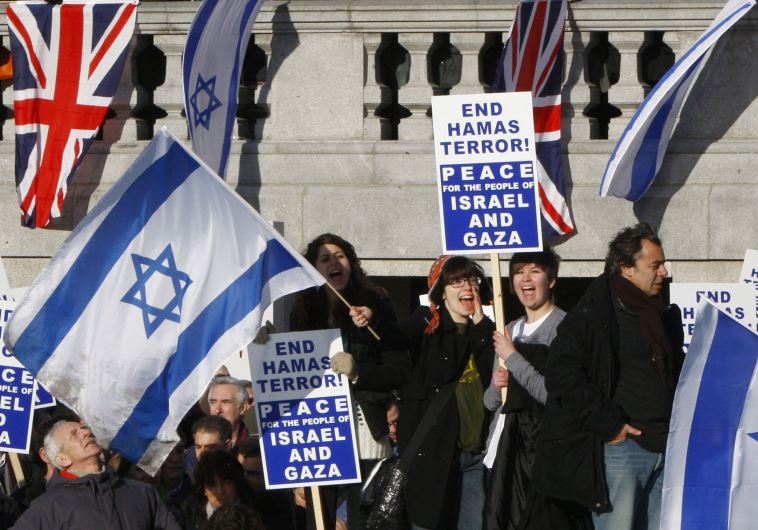 Pro-Israel demonstrators wave banners during a rally in London