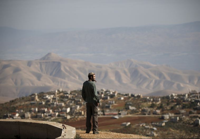 Settler Refael Morris stands at an observation point overlooking the West Bank village of Duma