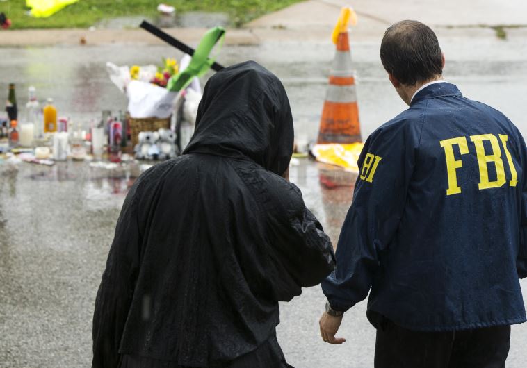 An FBI agent interviews a resident of Ferguson, Missouri.