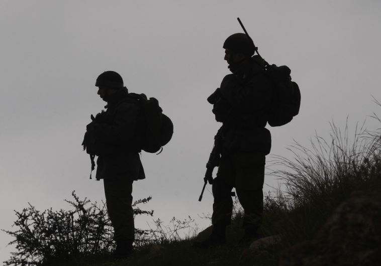 IDF soldiers stand guard during a demonstration by Palestinians