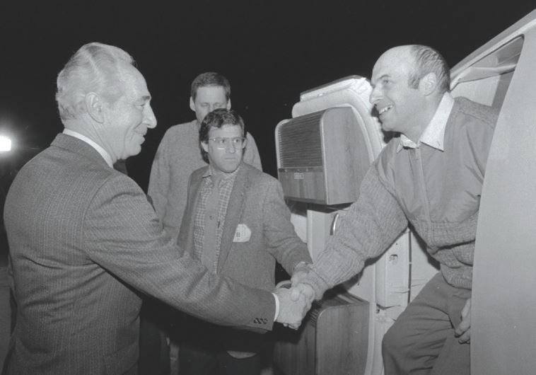 THEN PRIME MINISTER Shimon Peres greets newly released Prisoner of Zion Natan Sharansky at Ben-Gurion Airport where he was flown from Germany after being freed from a Soviet prison, February 11, 1986. (GPO)