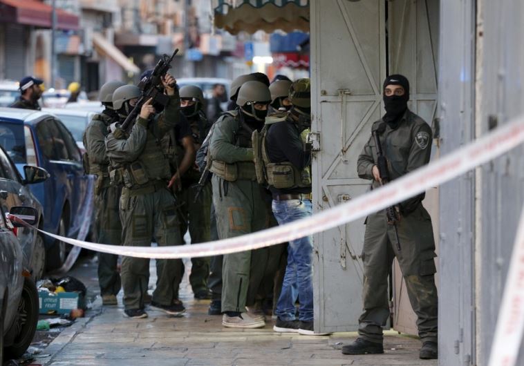 Israeli security forces search the scene of a shooting attack in Jerusalem
