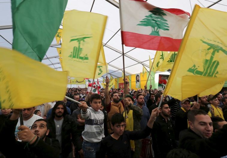 Supporters of Lebanon's Hezbollah leader Hassan Nasrallah wave Hezbollah and Lebanese flags