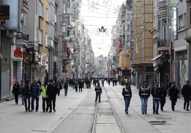 Plain clothes police walk on the main pedestrian street of Istiklal in central Istanbul during a May