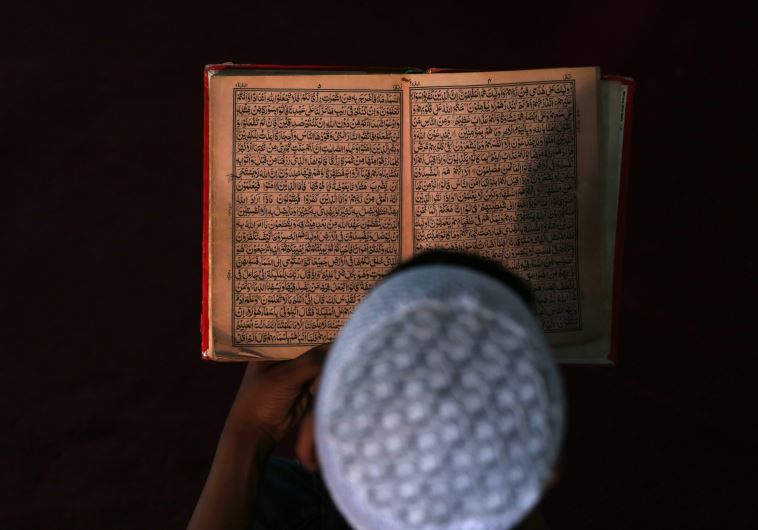 An Afghan boy reads the Koran in a madrasa, or religious school, during the Muslim holy month of Ram