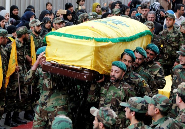 Rice is thrown as Hezbollah members carry the coffin of top Hezbollah commander Mustafa Badreddine