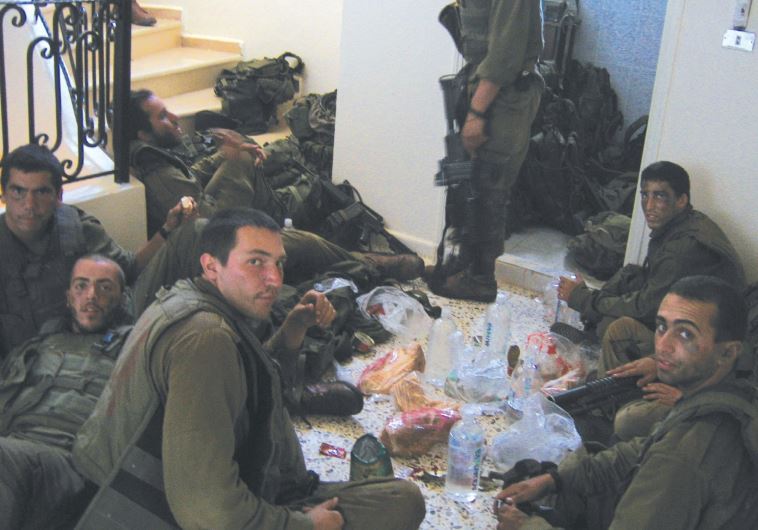 BENYAMIN BEN-ARI (third from left, foreground) and his buddies eat lunch in south Lebanon 10 years a