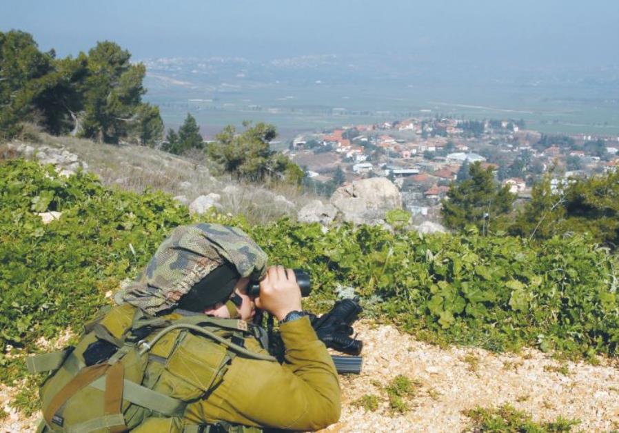 A SOLDIER near Metulla monitors Lebanon