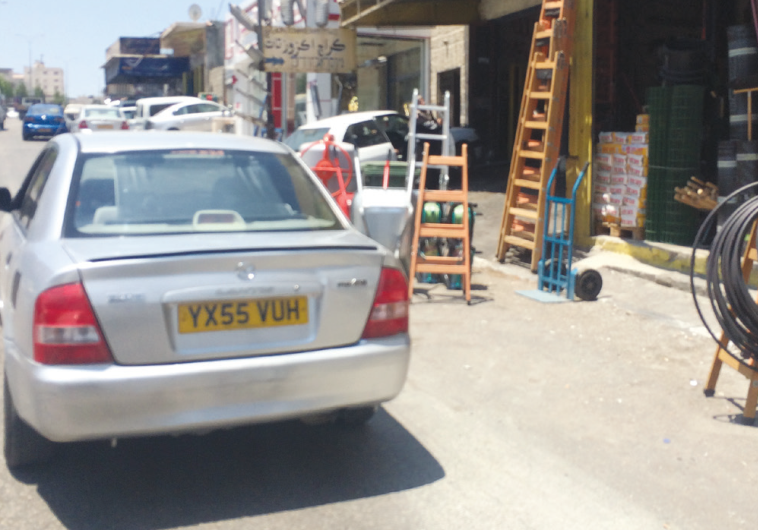 AN ILLEGAL late-model Mazda with false plates is seen yesterday on the main road of Eizariya.