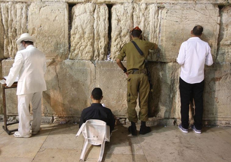 JEWS MOURN the destruction of the First and Second Temples at the Western Wall last night