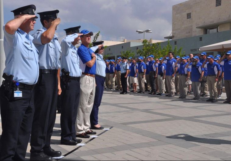 US and Israeli police officers salute each other during a Wednesday ceremony in Jerusalem’s Safra Sq