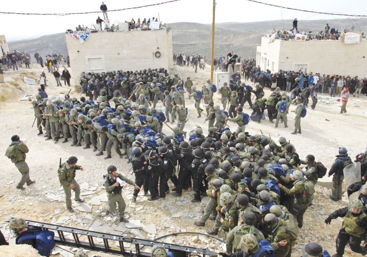 ISRAELI POLICEMEN gather in 2006 to remove the outpost of Amona.