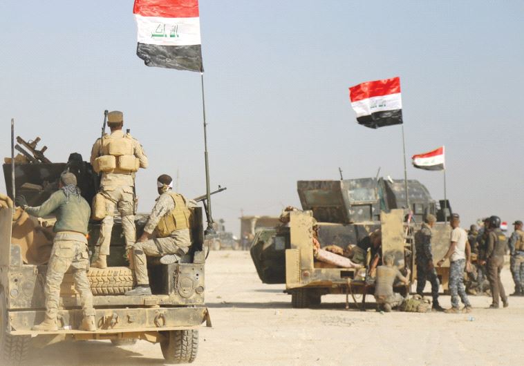 IRAQI FORCES advance in Qayara to attack Islamic State in Mosul yesterday.