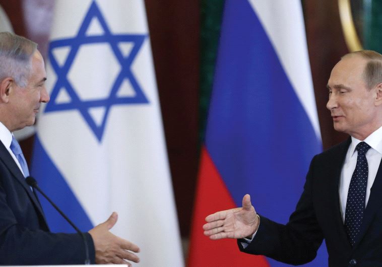 RUSSIAN PRESIDENT Vladimir Putin shakes hands with Prime Minister Benjamin Netanyahu during a news c