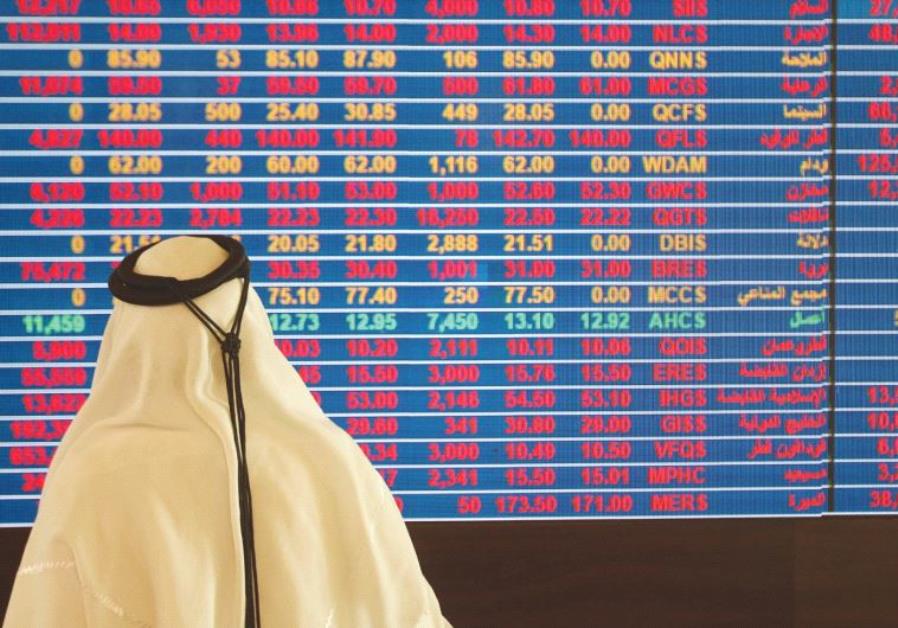 A TRADER monitors stock information at the Qatar Stock Exchange in Doha