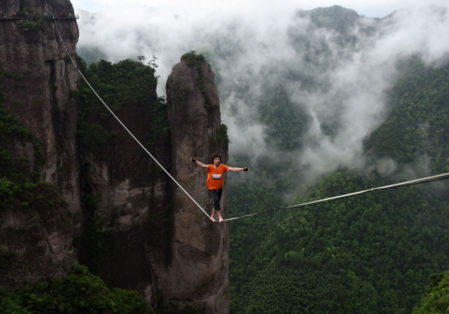 A competitor walks on tightrope