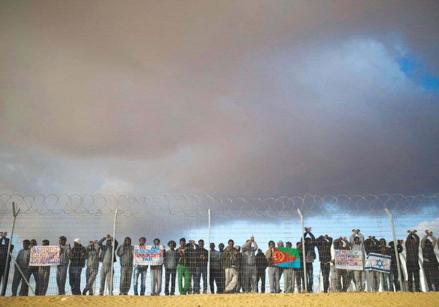 AFRICAN MIGRANTS being held at the Holot detention center in the Negev demonstrate last month for be