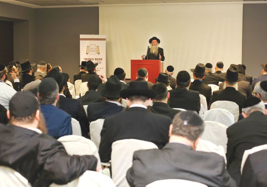 PARTICIPANTS AT THE Rabbinical Center of Europe conference listen as to a speaker address the organi