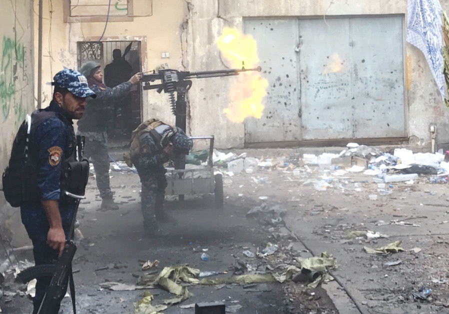 IRAQI SECURITY FORCES battle ISIS terrorists yesterday in western Mosul. 