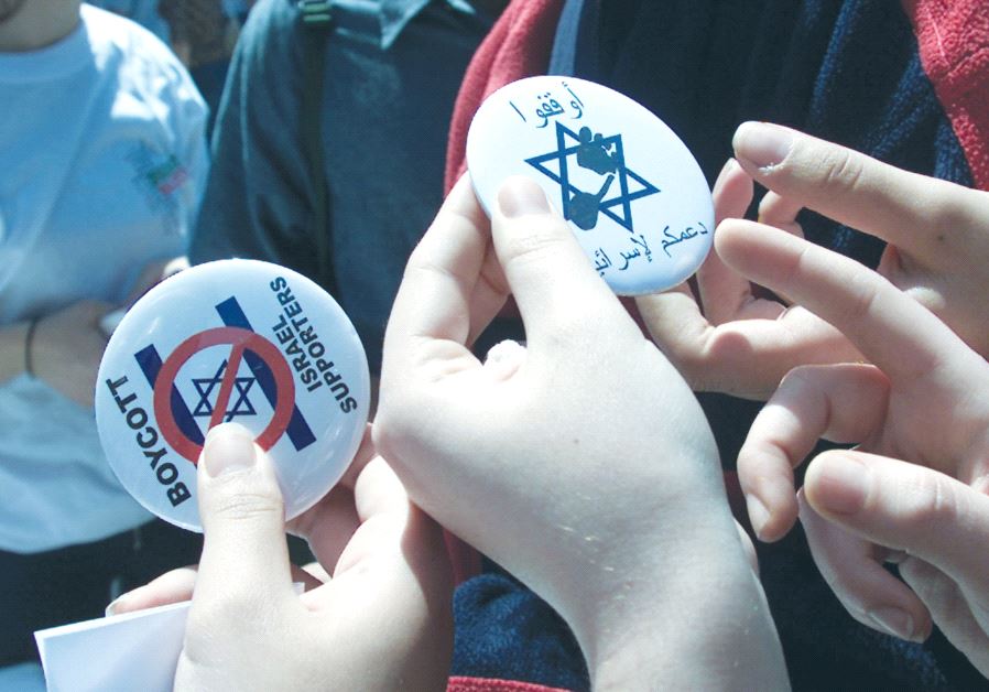 LEBANESE STUDENTS hand out buttons encouraging a boycott of Israel.