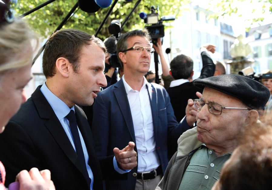 EMMANUEL MACRON talks with residents during a presidential campaign visit yesterday in Bagneres de B