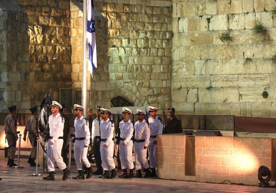 Soldiers rake down the flag ahead of Memorial Day ceremony at the Western Wall 