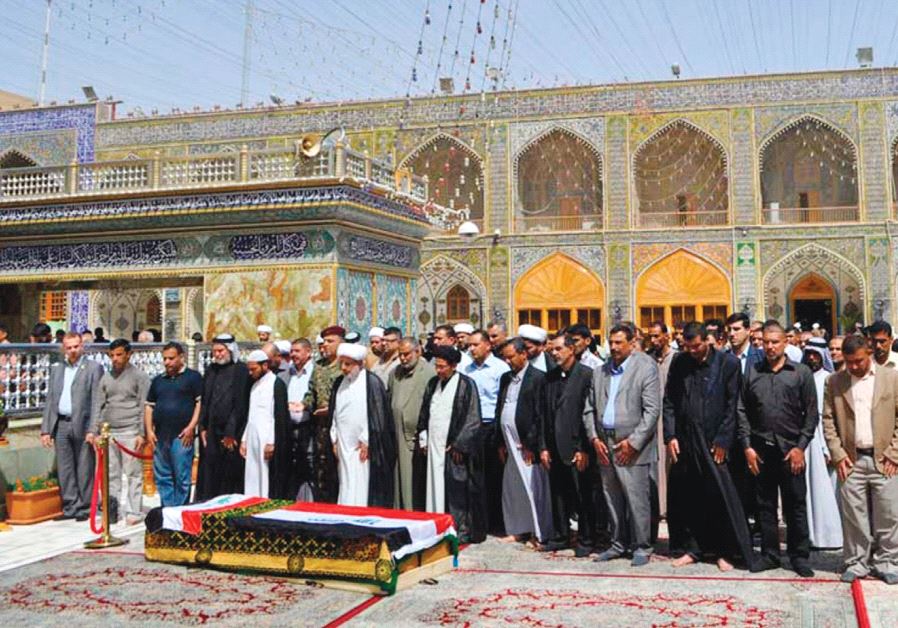 RESIDENTS PRAY near the coffin of Shaima Alawadi at the Imam Ali shrine in Najaf.