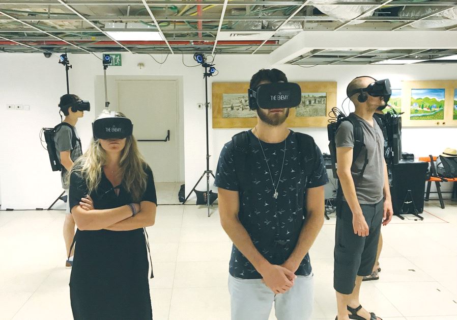 VIEWERS USE virtual-reality headsets to watch enemy combatants answer provocative questions at the Tel Aviv International Student Film Festival on Sunday.. (photo credit:ELIYAHU KAMISHER)