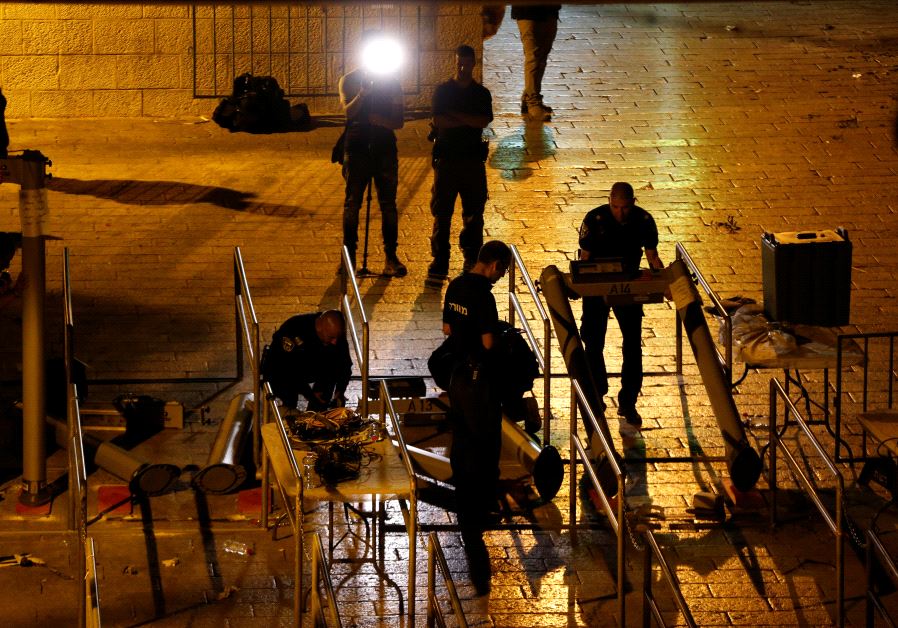 Israeli security forces remove metal detectors which were recently installed at an entrance to the Temple Mount (Reuters)