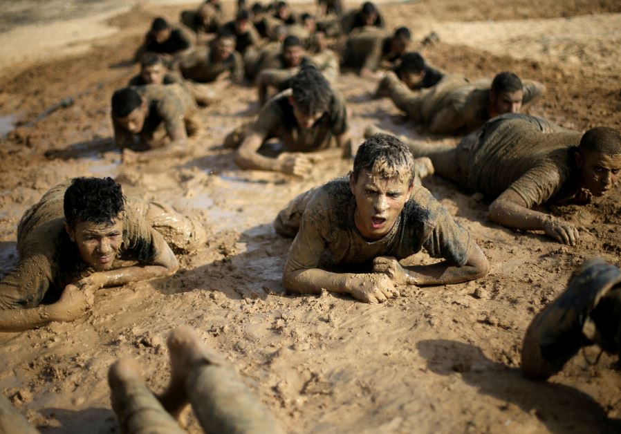 Young Palestinians crawl during a military-style exercise at a Hamas summer camp in Rafah in the southern Gaza Strip July 27, 2017. (Reuters)