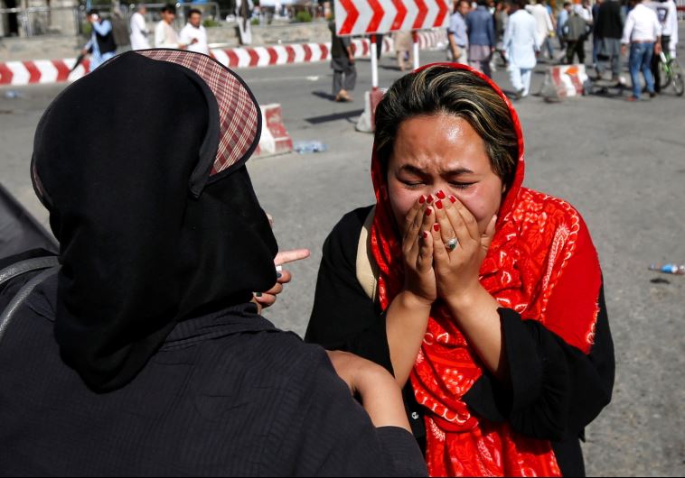An Afghan woman weeps at the site of a suicide attack in Kabul, Afghanistan July 23, 2016