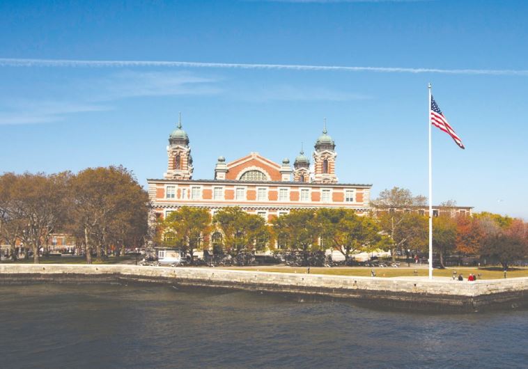 A US FLAG flies in front of the Ellis Island Immigration Museum in New York, October 2013