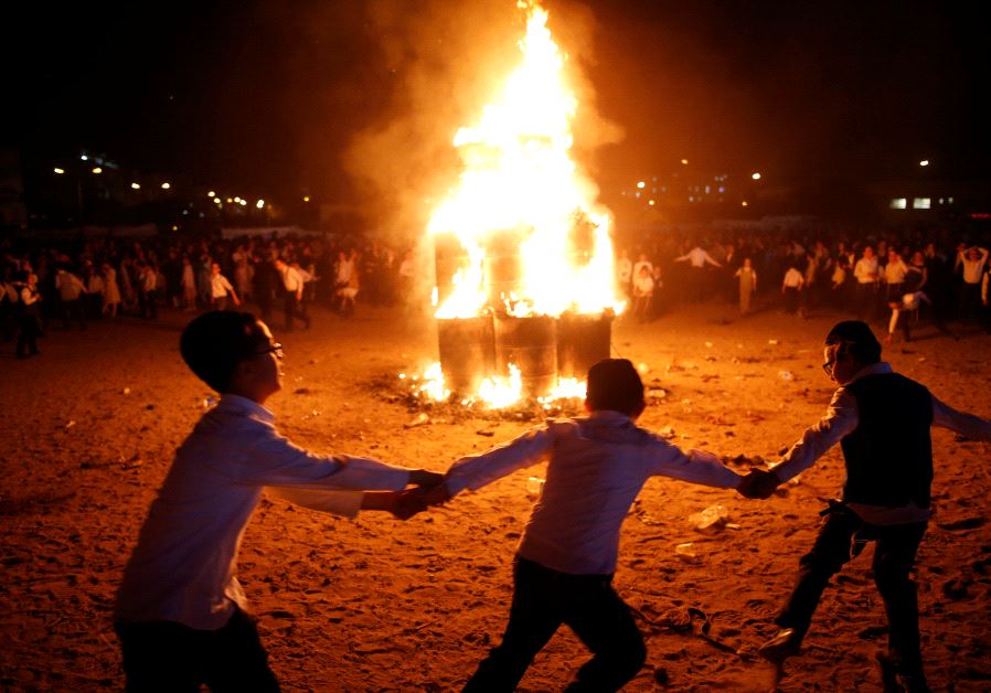 Ultra-Orthodox Jewish boys dance around a bonfire as they celebrate the Jewish holiday of Lag Ba'Ome