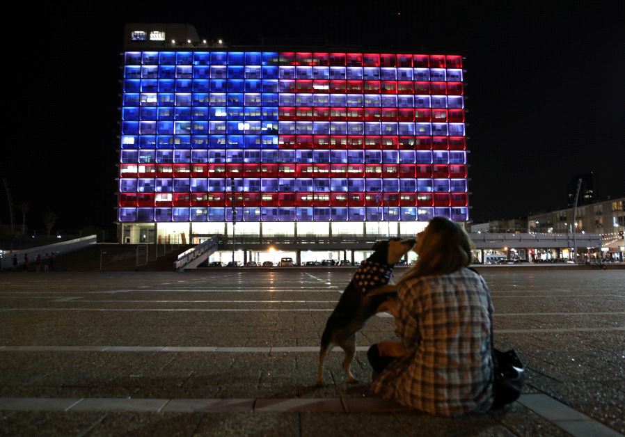 The Tel Aviv municipality building is lit in the colours of the American flag