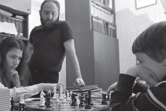 Russian chess grandmasters Boris Spassky, right, and Anatoly Karpov, left,  shake hands the news