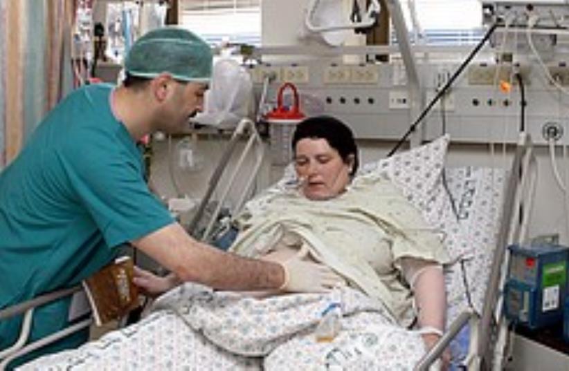 A doctor treats a patient at an Israeli hospital. (photo credit: Ariel Jerozolimksi)