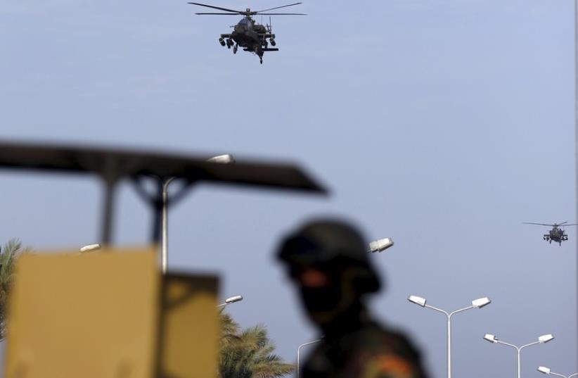 Egyptian military helicopters fly over a republican guard around the congress hall during the Arab Summit in Sharm el-Sheikh, in the South Sinai governorate, south of Cairo, March 28 (photo credit: REUTERS)