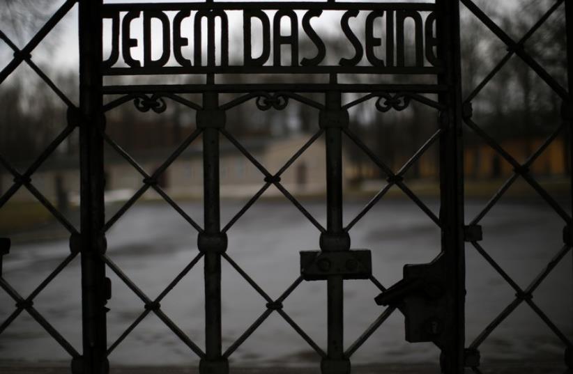 The camp gate with the inscription "to give each his due" is pictured at former concentration camp Buchenwald near Weimar  (photo credit: REUTERS)