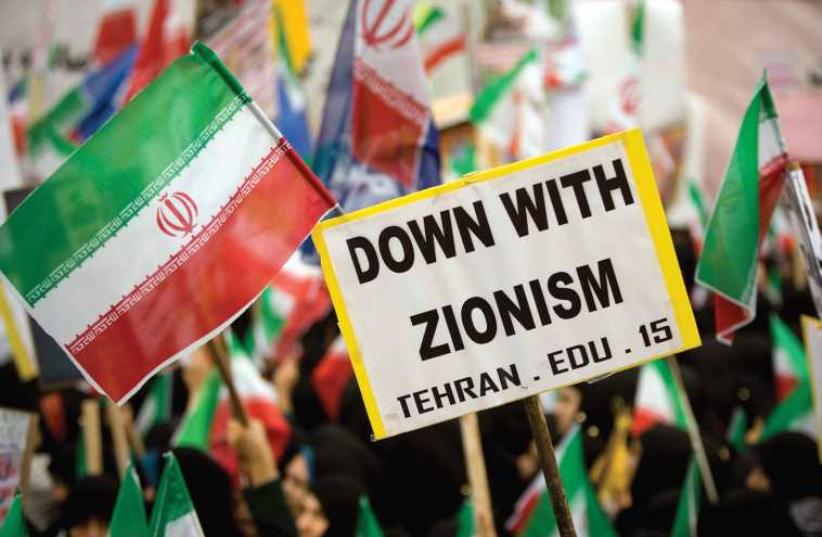 Iranian students hold anti-Israeli placards and Iranian flags during a rally outside the former US embassy in Tehran in 2009 (photo credit: REUTERS)