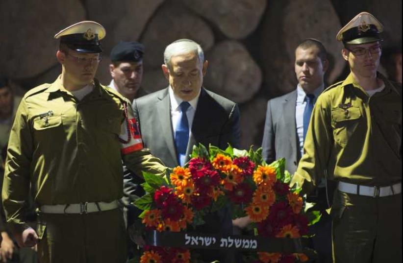 Netanyahu lays wreath during Holocaust Remembrance Day Ceremony at Yad Vashem in Jerusalem‏ (photo credit: AMOS BEN GERSHOM, GPO)