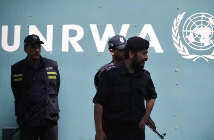 Palestinian policemen loyal to Hamas guard outside the UNRWA headquarters in Gaza City (photo credit: REUTERS)
