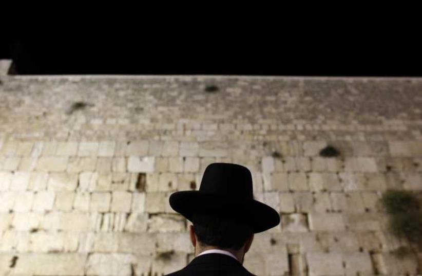 An Orthodox Jewish worshipper prays at the Western Wall, Judaism's holiest prayer site, in Jerusalem's Old City (photo credit: REUTERS)